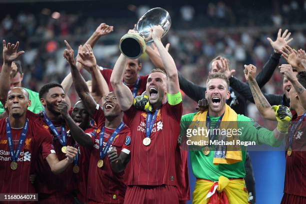 Jordan Henderson of Liverpool lifts the UEFA Super Cup trophy as Liverpool celebrate victory following the UEFA Super Cup match between Liverpool and...