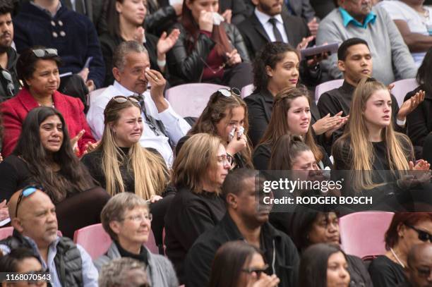 People mourn at the memorial service for Chester Williams, who played wing for the South African Springbok team which won the historic 1995 Rugby...