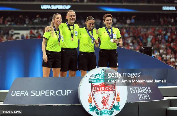 Assistant referee Manuela Nicolosi, fourth official, Cüneyt Çakır, match referee Stephanie Frappart and assistant referee Michelle O Neill pose with...