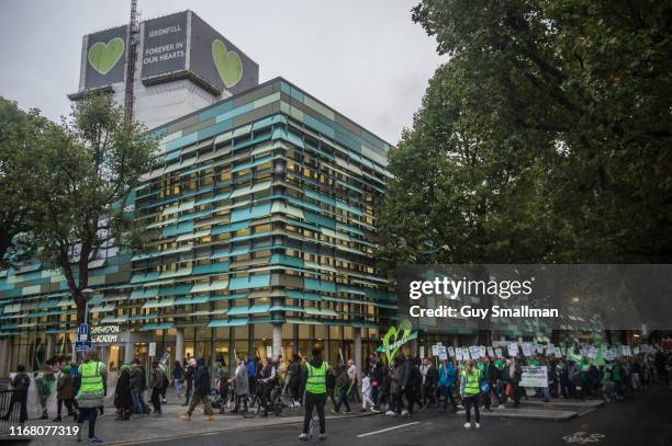 Survivors of the Grenfell Tower disaster are joined by Fire Fighters and supporters on the monthly silent march at Grenfell Tower on August 14, 2019...