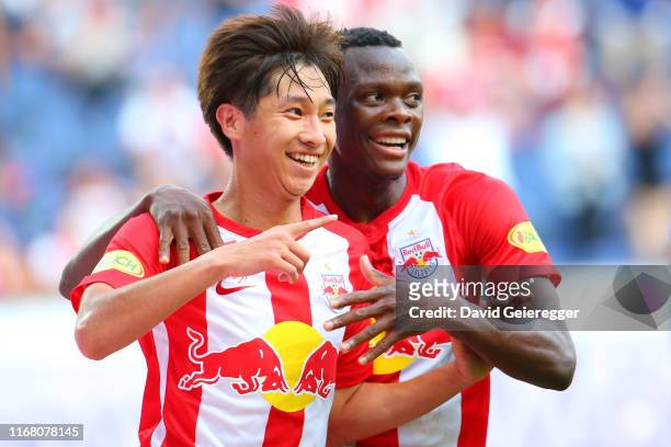 Masaya Okugawa of Salzburg celebrates with his teammate Patson Daka of Salzburg after scoring during the tipico Bundesliga match between FC Red Bull...