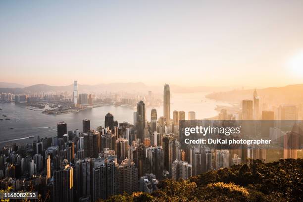 sunrise over victoria harbor hong kong - aerial hong kong stock-fotos und bilder
