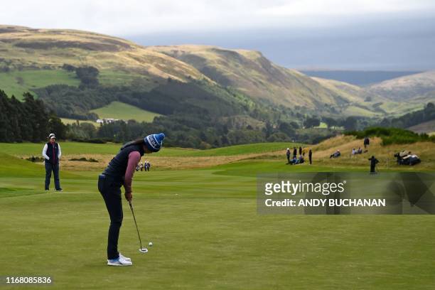 Europe's Georgia Hall putts on the 3rd green during the fourballs on the second day of The Solheim Cup golf tournament at the Gleneagles Hotel in...