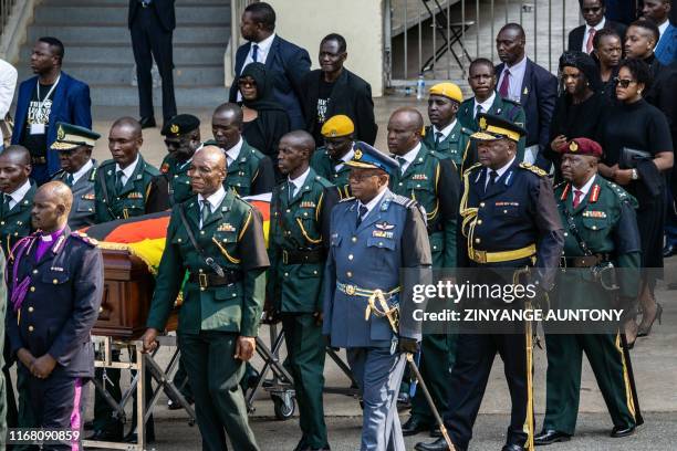 Zimbabwe's First Lady Grace Mugabe , her daughter Bona Mugabe Chikore and son Bellermine Chatunga Mugabe follow pallbearers carrying the casket after...