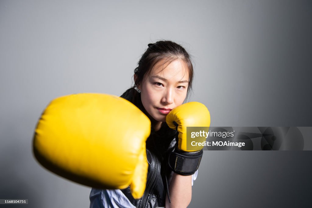 A young Asian woman in sportswear is exercising