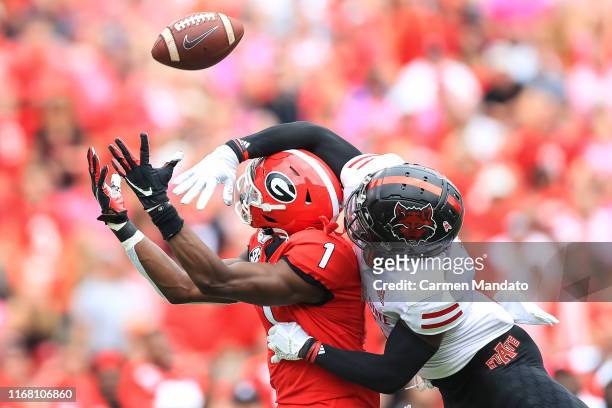 George Pickens of the Georgia Bulldogs reaches for a pass under coverage from Jerry Jacobs of the Arkansas State Red Wolves during the first half of...
