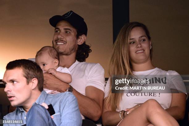 Paris Saint-Germain's Uruguayan forward Edinson Cavani holds his baby next to his girlfriend Jocelyn Burgardt attend the French L1 football match...