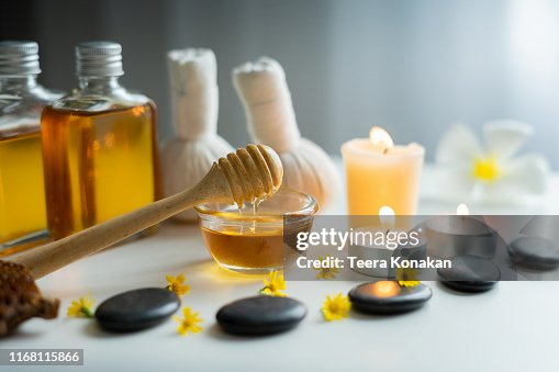 Closeup on honey spa therapy ingredients and salt spa objects Closeup on honey spa therapy ingredients and salt spa objects
