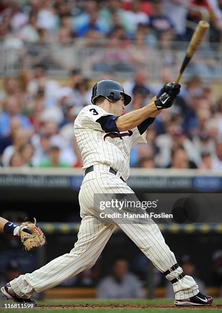 Joe Mauer of the Minnesota Twins gets an RBI single against the San Diego Padres in the first inning on June 17, 2011 at Target Field in Minneapolis,...