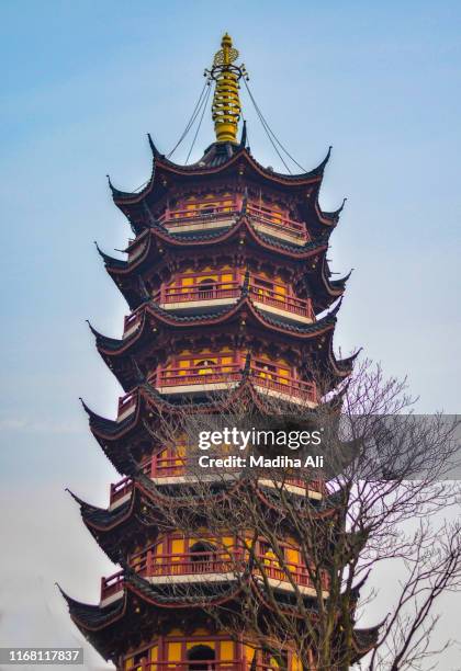 jiming temple, a holy site and a tourist resort in the outdoors within the cityscape of nanjing, jiangsu province, china. - shanghai temple stock pictures, royalty-free photos & images