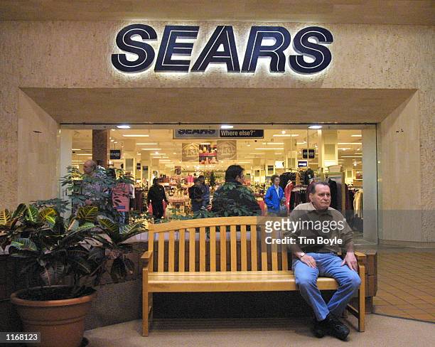 Shopper rests on a bench near a Sears store October 24, 2001 in Niles, IL. Sears, Roebuck and Co. Said Wednesday, October 24, 2001 that it is...