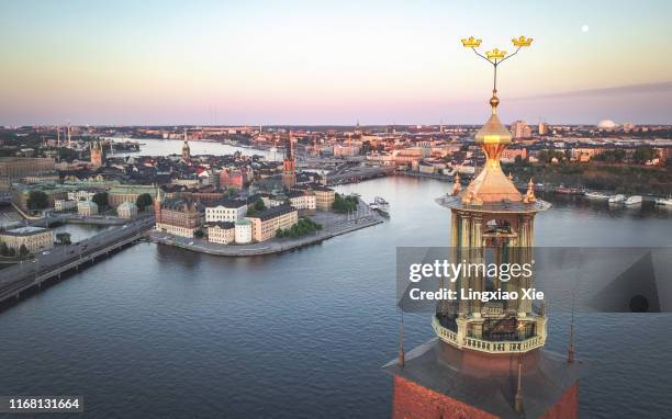 aerial view of stockholm city hall and three crowns, with skyline of riddarholmen, gamla stan and södermalm at sunset, stockholm, sweden - stockholm skyline stock pictures, royalty-free photos & images