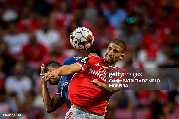 Benfica's Moroccan midfielder Adil Taarabt heads the ball during the Portuguese League football match between SL Benfica and Gil Vicente FC at the...