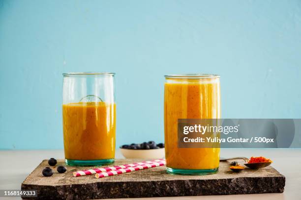 mango banana turmeric smoothie - mango smoothie stock pictures, royalty-free photos & images