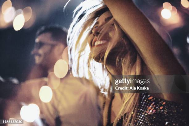 young couple dancing at music festival. - party atmosphere stock pictures, royalty-free photos & images