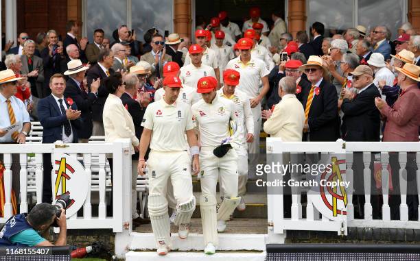 England and Australia teams walks from the pavilion ahead of day two of the 2nd Specsavers Ashes Test match at Lord's Cricket Ground on August 15,...