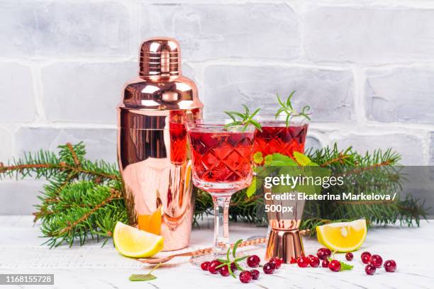 cranberry coctail with rosemary - tangerine martini stock pictures, royalty-free photos & images