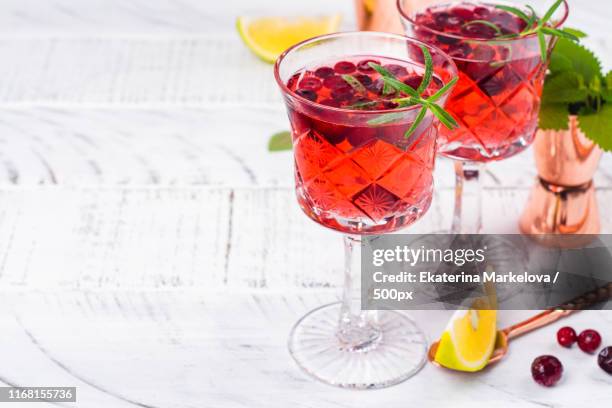 cranberry cocktail with rosemary - tangerine martini stock pictures, royalty-free photos & images