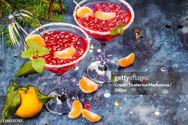 pomegranage and tangerine martini - tangerine martini stock pictures, royalty-free photos & images