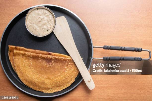 maida dosa with coconut chutneyin tawa, south indian breakfast - thosai stock pictures, royalty-free photos & images