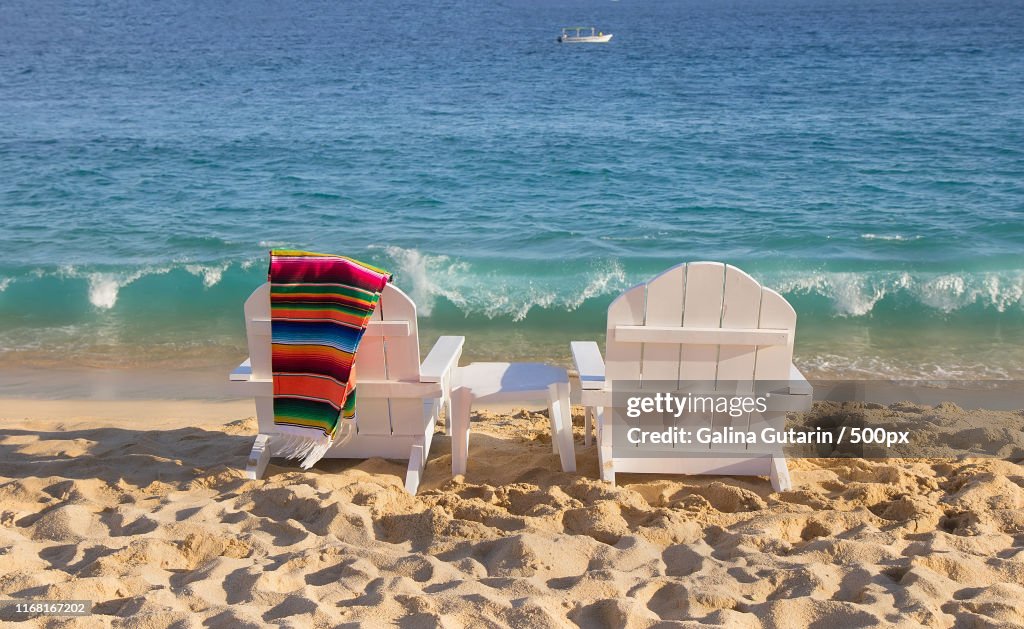 Two Beach Chairs With Serape Near Ocean