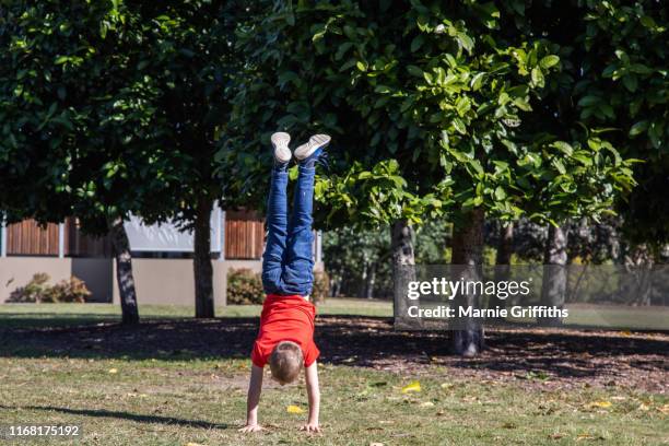 young boy doing a handstand - boy handstand stock pictures, royalty-free photos & images