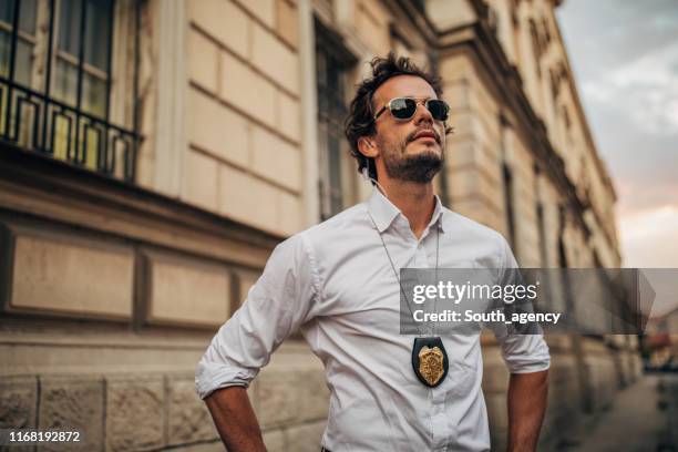 handsome detective on the street - intelligence agency stock pictures, royalty-free photos & images