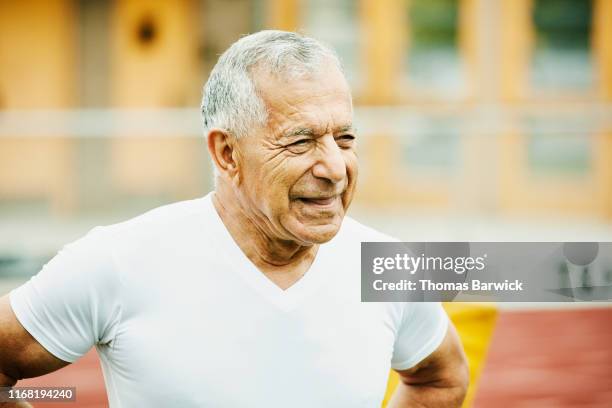 portrait of senior male track athlete after running race on track - arab old man fotografías e imágenes de stock