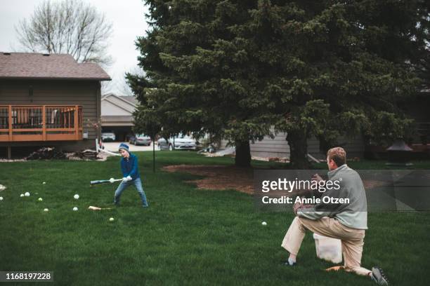 father and son practicing baseball - backyard baseball stock pictures, royalty-free photos & images