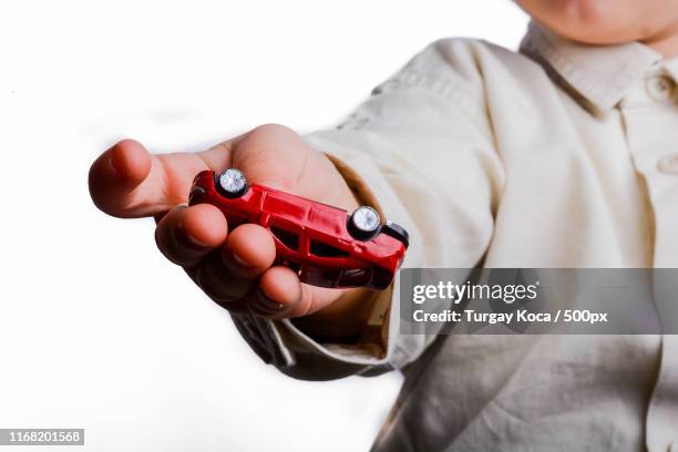 baby hand holding a red car - toy car white background stock pictures, royalty-free photos & images