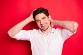 Close up photo of handsome man showing his attractiveness via camera while isolated with red background
