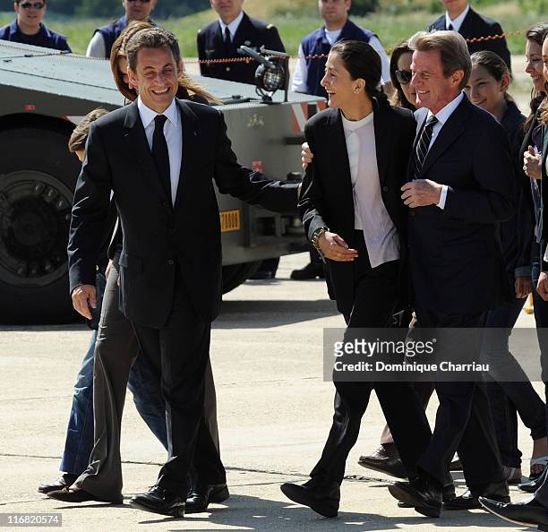 Freed hostage Ingrid Betancourt is accompanied by French president Nicolas Sarkozy and Bernard Kouchner on her arrival at the military base of...