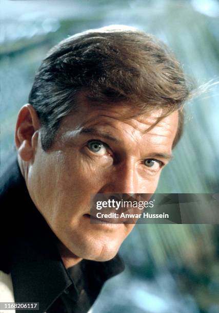 Roger Moore poses on location for the filming of the James Bond film 'Live And Let Die' on March 1, 1973 in Kingston, Jamaica