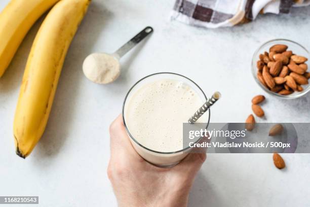 protein banana milkshake or smoothie - protein shake stock-fotos und bilder