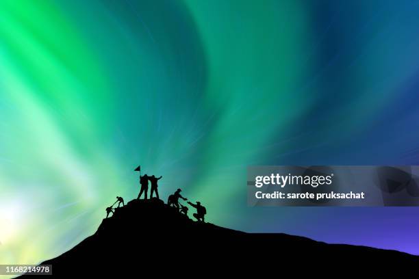 silhouette  climbing group friends standing to hike up mountain .teamwork , helps ,success, winner and leadership concept . - alto foto e immagini stock