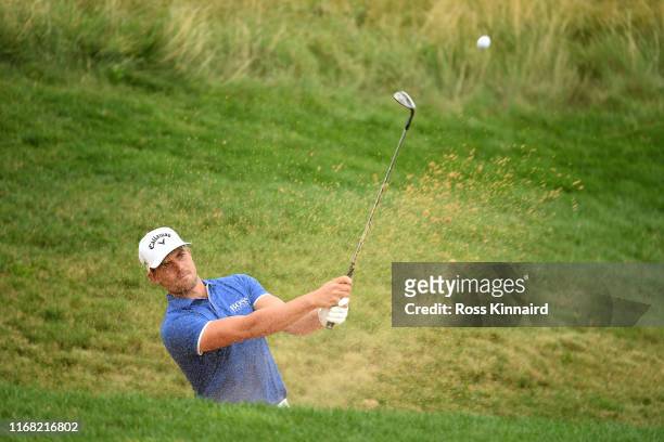 Haydn Porteous of South Africa plays out of a bunker on the seventeenth during Day one of the D+D Real Czech Masters at the Albatross Golf Resort on...