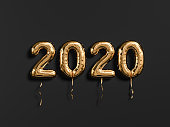 New year 2020 celebration. Gold foil balloons numeral 2019 and on black wall background