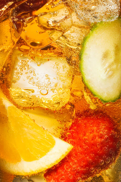 close up shot of fruit in liquid - orange cocktail stock pictures, royalty-free photos & images