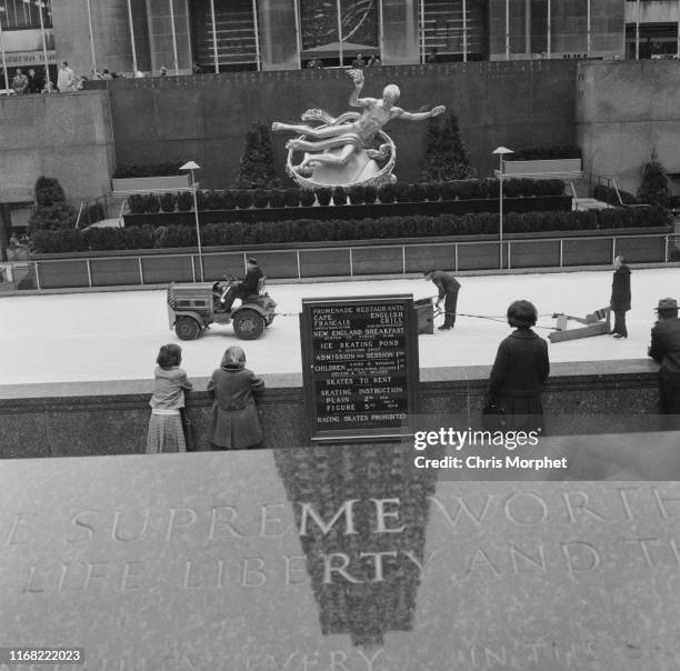 People watching the ice being resurfaced on the skating rink in Rockefeller Plaza, New York City, 1964. In the background is Paul Manship's...