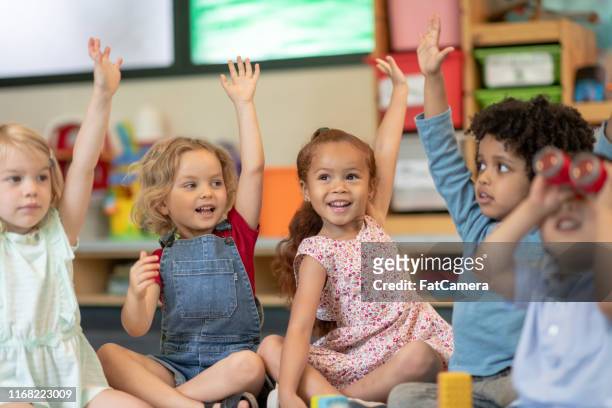 multi-ethnic group of students in class - preschool stock pictures, royalty-free photos & images