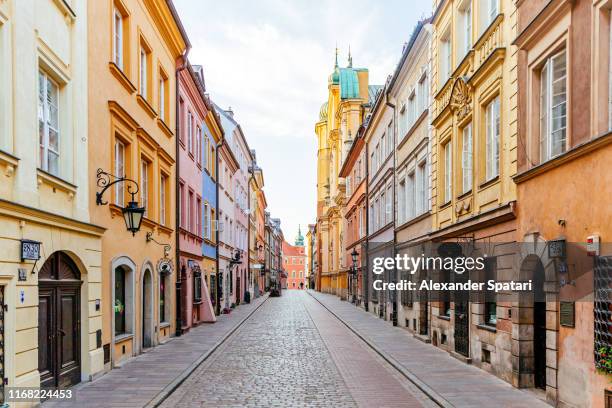 colorful street in warsaw old town, poland - poland stock-fotos und bilder