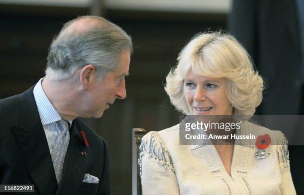 Prince Charles, Prince of Wales and Camilla, Duchess of Cornwall exchange glances as they watch a demonstration of Kendo sword fighting at the...