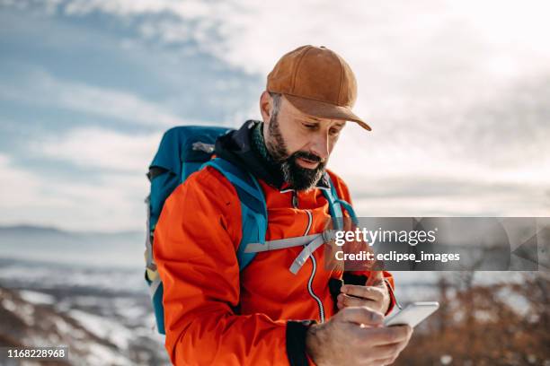 i have to set destination on my phone - orange jacket stock pictures, royalty-free photos & images