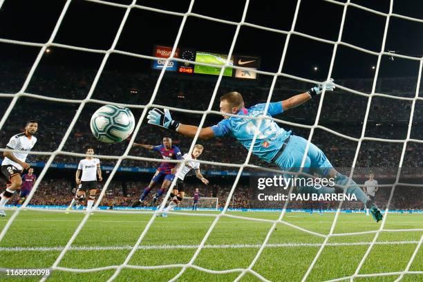 Valencia's Dutch goalkeeper Jasper Cillessen fails to catch a goal scored by Barcelona´s Guinea-Bissau forward Ansu Fati during the Spanish league...