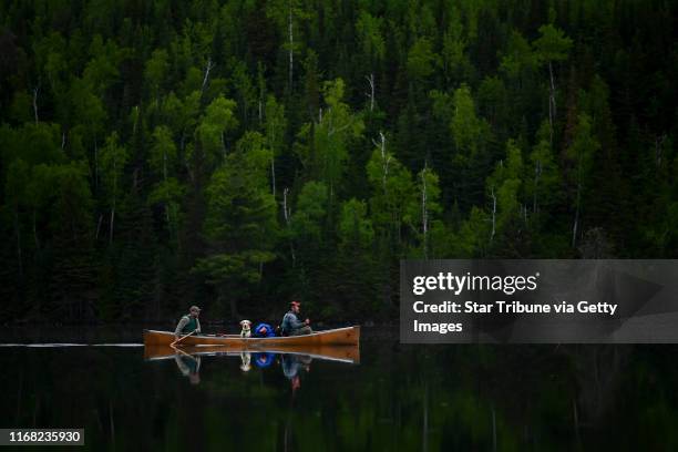 Tony Jones, his dog Crosby, and Bob Timmons paddled from Mountain Lake toward their portages to Moose Lake Friday. Tony Jones, his 14-year old son...