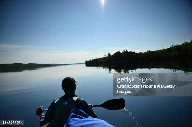 Bob Timmons paddled in the bow of a canoe while on Gunflint Lake Tuesday morning. Tony Jones, his 14-year old son Aidan, their friend Brad Shannon...