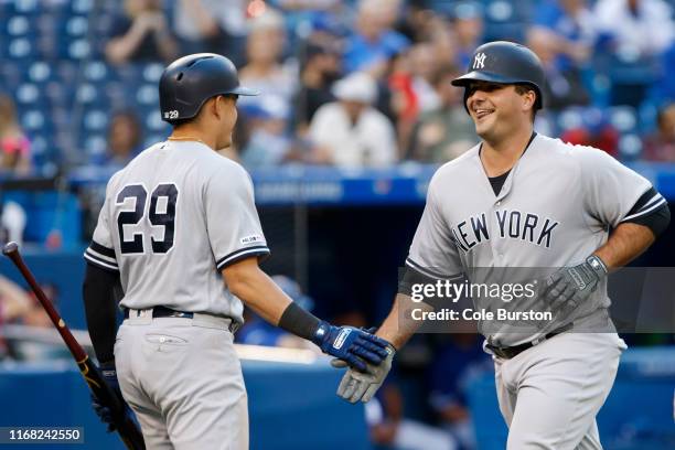 Mike Ford of the New York Yankees celebrates a home run with Gio Urshela in the ninth inning of their MLB game against the Toronto Blue Jays at...