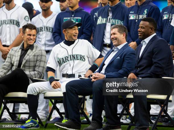 Seattle Mariners general manager Jerry Dipoto looks on as Ichiro Suzuki, center laughs with former Seattle Mariners players Edgar Martinez and Ken...