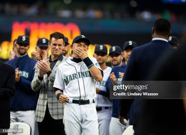 Ichiro Suzuki of the Seattle Mariners laughs as Ken Griffey Jr. And Edgar Martinez greet him before receiving the Seattle Mariners Franchise...