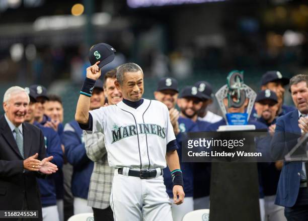 Former Seattle Mariners player Ichiro Suzuki tips his cap to the crowd as he receives the Seattle Mariners Franchise Achievement Award before the...